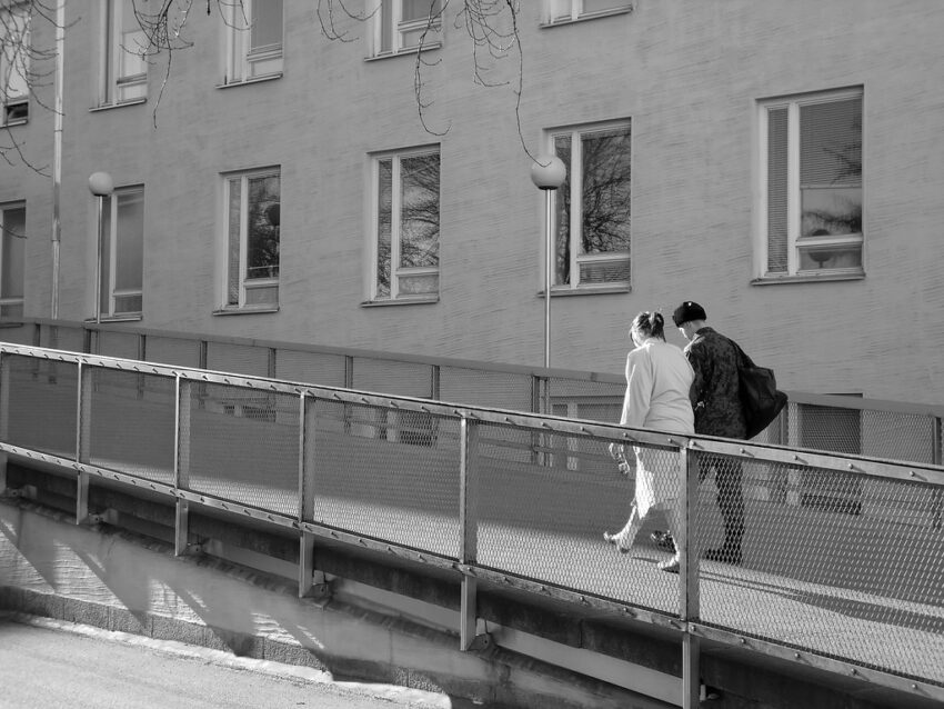 people walking in front of a building, black and whtie photo
