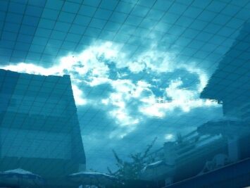 Picture of sky as if looking up from under water, with pool tiles reflected onto sky