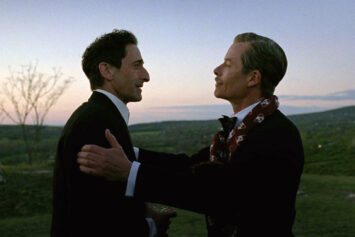 A movie still of Adrien Brody and Guy Pearce at dusk in “The Brutalist”