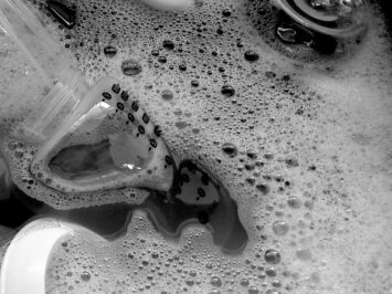 Dishes in a sink full of suds