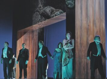 Group of people on stage in dim light