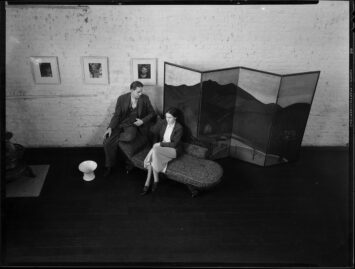 A man and woman talking on a sofa