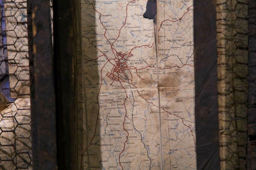 A paper map behind fencing.