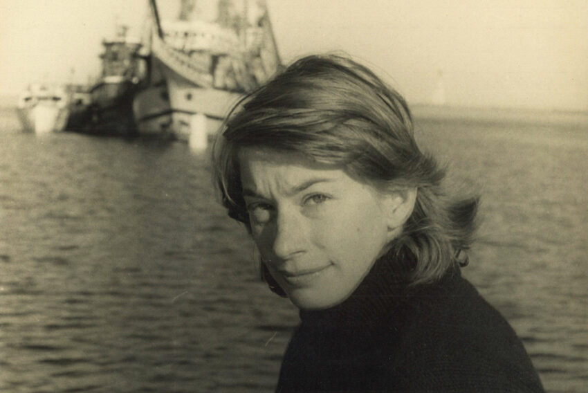 Sepia-toned image of Mary Oliver by the sea