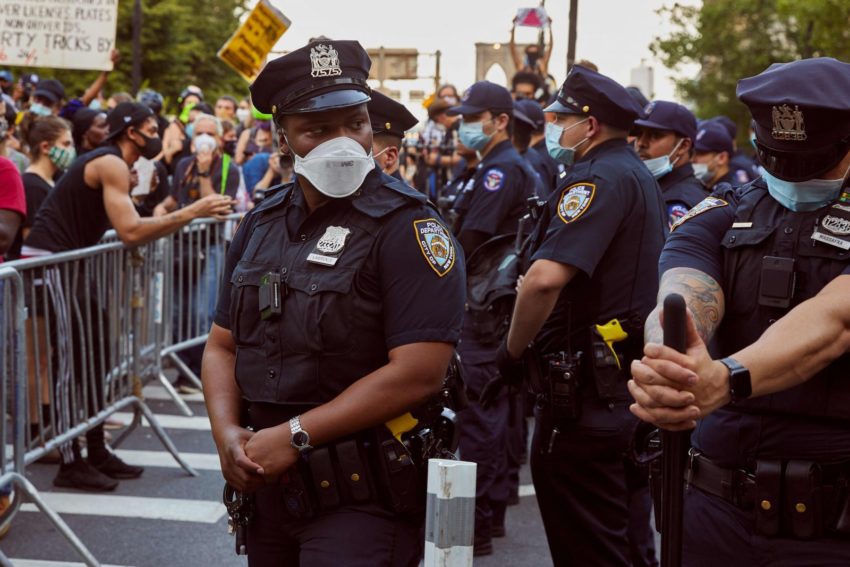 Police officers beside protestors