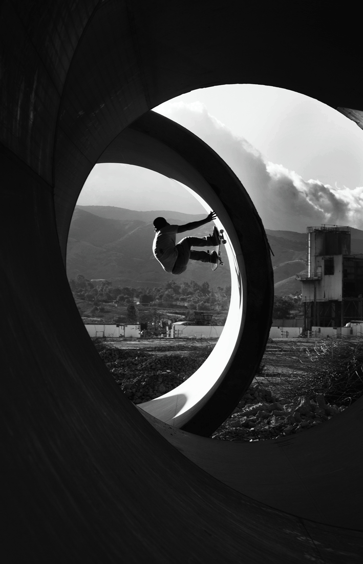 Photograph of skater on a loop-shaped ramp